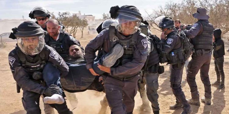 Israeli police detain a man as Bedouins